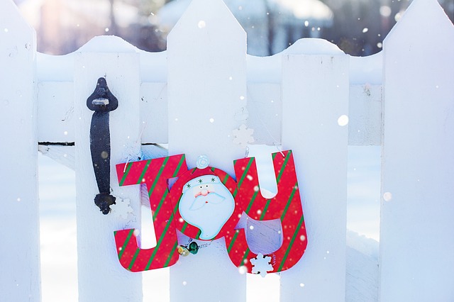 The word "Joy" hanging from a door knob in winter