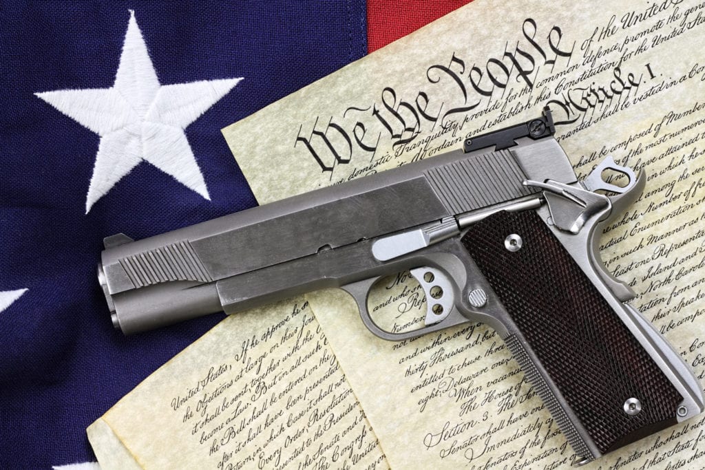 Pistol on Constitution and American flag
