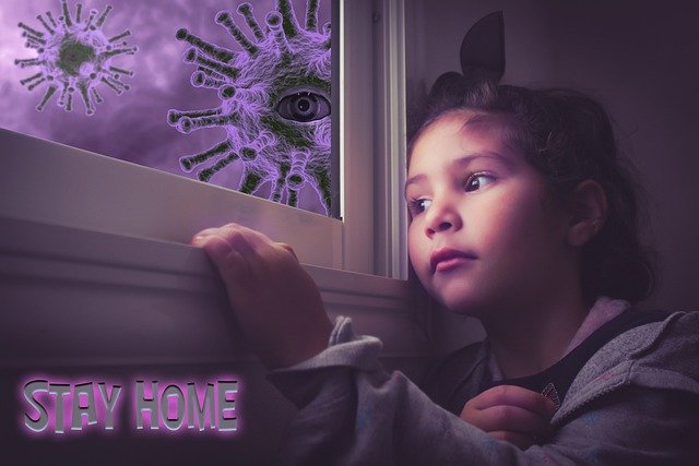 A little girl looking out of her window at illustrations of the corona virus floating around outside. In the corner it says "stay home"